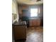 Kitchen area with wooden cabinets, copper colored backsplash, black appliances, and patterned flooring at 1105 N Livingston Ave, Indianapolis, IN 46222