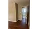 Living room leading to a bathroom with hardwood floors and neutral walls at 1105 N Livingston Ave, Indianapolis, IN 46222