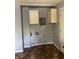 Small utility room with old cabinets and connections for a washer and dryer at 1105 N Livingston Ave, Indianapolis, IN 46222