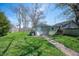 Backyard with grass and a path leading to a shed with a white door at 1217 Evison St, Indianapolis, IN 46203