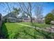 Large backyard with green grass, a sidewalk and some trees under a blue sky at 1217 Evison St, Indianapolis, IN 46203