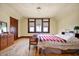 Inviting bedroom featuring a large window, wooden floors, and classic furnishings at 1217 Evison St, Indianapolis, IN 46203