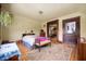 Spacious bedroom with natural light, decorative rug, hardwood floors and a decorative bench at 1217 Evison St, Indianapolis, IN 46203