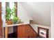 Cozy staircase with a stained glass window and natural light from adjacent plants at 1217 Evison St, Indianapolis, IN 46203