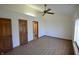 Spacious bedroom featuring a ceiling fan, two closets, and wood-look flooring at 12731 Slippery Rock Rd, Indianapolis, IN 46236