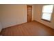 View of a bedroom with light-colored walls, wood-look flooring, and a window at 12731 Slippery Rock Rd, Indianapolis, IN 46236