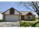 Charming single-story home featuring a brick facade, attached garage, and well-maintained front lawn at 12731 Slippery Rock Rd, Indianapolis, IN 46236