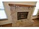 Traditional brick fireplace with wood mantel, providing a cozy focal point in the living area at 12731 Slippery Rock Rd, Indianapolis, IN 46236