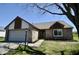 Charming brick home with attached garage, manicured lawn, and inviting curb appeal at 12731 Slippery Rock Rd, Indianapolis, IN 46236