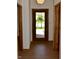 Entryway hallway featuring wood floors, neutral walls, and a view of the front door at 12731 Slippery Rock Rd, Indianapolis, IN 46236