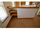 Open kitchen bar area with wood floors, storage, and view to the stainless steel appliances at 12731 Slippery Rock Rd, Indianapolis, IN 46236