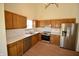 Well-equipped kitchen with wood cabinetry, stainless steel appliances, and ample counter space at 12731 Slippery Rock Rd, Indianapolis, IN 46236