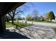 View from garage showing peaceful neighborhood street with mature trees and well-kept lawns at 12731 Slippery Rock Rd, Indianapolis, IN 46236