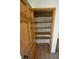 View of a walk-in pantry with open, wooden shelving and wood-look floors at 12731 Slippery Rock Rd, Indianapolis, IN 46236