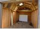 Shed interior featuring wooden framing and a skylight for natural light at 12731 Slippery Rock Rd, Indianapolis, IN 46236