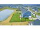 Aerial view of neighborhood with pond and backyard play-set at 12959 Girvan Way, Fishers, IN 46037