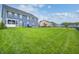 Large backyard featuring a vast lawn, blue siding, and a neighborhood play-set at 12959 Girvan Way, Fishers, IN 46037