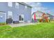 The backyard includes a patio, grill, and green space with a playset at 12959 Girvan Way, Fishers, IN 46037