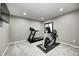 This finished basement features a treadmill, exercise bike, light gray walls, light gray carpet, and recessed lighting at 12959 Girvan Way, Fishers, IN 46037