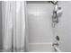 This tiled shower with a white shower curtain features a shower head with mounted storage at 12959 Girvan Way, Fishers, IN 46037