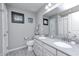 Bright bathroom featuring a double sink vanity, gray walls, gray tile floor and window with horizontal blinds at 12959 Girvan Way, Fishers, IN 46037