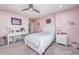 Pink bedroom features white furniture, a ceiling fan, and great natural light at 12959 Girvan Way, Fishers, IN 46037