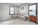 Comfortable bedroom featuring a sofa, neutral walls, carpet, and two windows with dark shutters at 12959 Girvan Way, Fishers, IN 46037