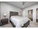 Bedroom featuring a neutral color scheme, carpet, a ceiling fan and an adjoining bathroom at 12959 Girvan Way, Fishers, IN 46037