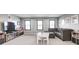 Spacious bonus room features a large gray sectional, playroom table, and plenty of storage at 12959 Girvan Way, Fishers, IN 46037