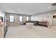 Large bonus room with neutral walls, a gray sectional, and plenty of room to relax and play at 12959 Girvan Way, Fishers, IN 46037