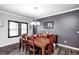 Dining room features a dining table set for six, wood floors, crown molding, and a modern chandelier at 12959 Girvan Way, Fishers, IN 46037