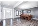 Dining room features hardwood floors, white trim, chandelier, and a dining table set for six at 12959 Girvan Way, Fishers, IN 46037