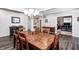 Dining room features hardwood floors, a wood table, a chandelier, and access to an office at 12959 Girvan Way, Fishers, IN 46037