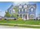 Beautiful two-story home with blue siding, stone accents, dormer windows, and a well-maintained front yard at 12959 Girvan Way, Fishers, IN 46037