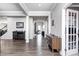 Open hallway featuring hardwood floors, white trim, and modern wood furniture at 12959 Girvan Way, Fishers, IN 46037