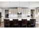 Bright kitchen featuring stainless appliances, large island with seating, and stylish pendant lights at 12959 Girvan Way, Fishers, IN 46037