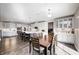 Large, bright kitchen with white cabinetry, stainless steel appliances, and an island with bar seating at 12959 Girvan Way, Fishers, IN 46037