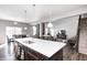 Kitchen island with a breakfast bar is open to a living and dining area for easy entertaining at 12959 Girvan Way, Fishers, IN 46037