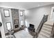 Spacious living room with vaulted ceilings, natural stone fireplace, and large picture windows for ample natural light at 12959 Girvan Way, Fishers, IN 46037