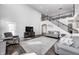 Open living room with cathedral ceilings, lots of comfortable seating, and a view of the staircase at 12959 Girvan Way, Fishers, IN 46037