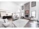 Bright living room with stone fireplace, cathedral ceilings, and lots of comfortable seating at 12959 Girvan Way, Fishers, IN 46037