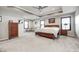 Large main bedroom featuring tray ceilings, carpet, with a lounge area and ensuite bathroom at 12959 Girvan Way, Fishers, IN 46037