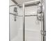 Bright walk-in shower with white tile surround, shower seat and glass enclosure at 12959 Girvan Way, Fishers, IN 46037