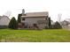 Expansive backyard with a deck, hot tub, mature trees, and a lush lawn perfect for outdoor gatherings and relaxation at 1401 Runningbrook Ln, Avon, IN 46123