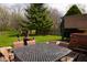 Backyard featuring a patio set, a lawn, and a hot tub surrounded by greenery at 1401 Runningbrook Ln, Avon, IN 46123