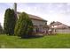 Spacious backyard featuring a deck, outdoor seating, and a well-manicured lawn, great for entertaining at 1401 Runningbrook Ln, Avon, IN 46123