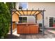 Backyard area featuring a covered hot tub and a serene outdoor setup at 1401 Runningbrook Ln, Avon, IN 46123