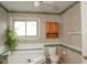 Traditional bathroom featuring a garden tub, paneled walls, toilet, and wood cabinet at 1401 Runningbrook Ln, Avon, IN 46123