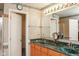Bathroom featuring a double sink vanity and a doorway to the closet at 1401 Runningbrook Ln, Avon, IN 46123
