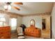 Cozy bedroom with lots of light, dresser, and doorway to the en suite bathroom at 1401 Runningbrook Ln, Avon, IN 46123